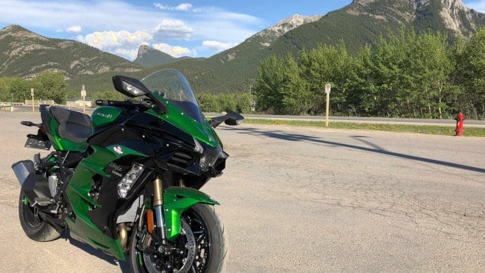 2018 Kawasaki Ninja H2SXSE with mountains in the background.