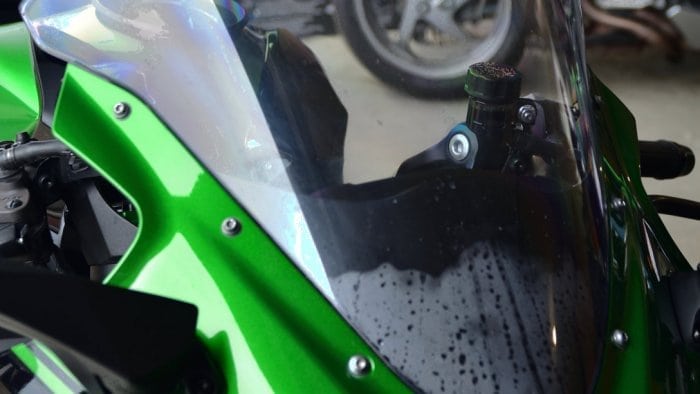 Moisture trapped behind the windshield of a 2018 Kawasaki Ninja H2SXSE.