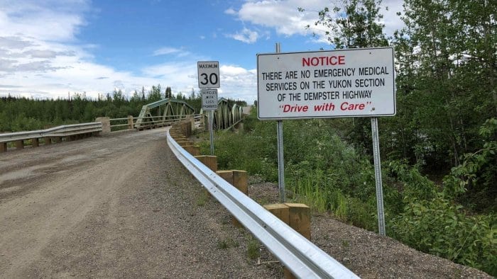 Warning sign at the beginning of the Dempster Highway, Yukon. No emergency services.