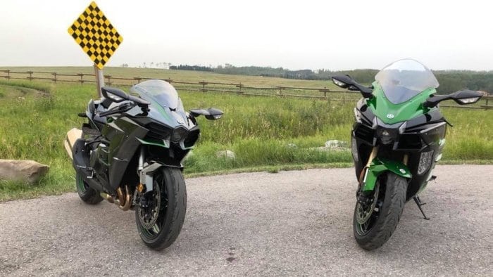 The Kawasaki H2 and H2SX SE together in a parking lot.