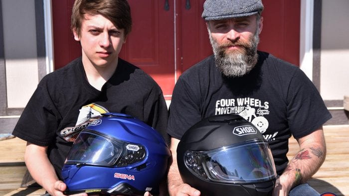 Father and son holding the Shoei GT Air and GT Air II helmets.