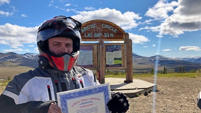 Me standing in front of the marker for the Arctic Circle in Canada's Yukon Territory.