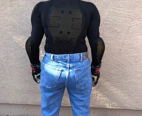 Forcefield Pro Jacket X-V2 rearview tucked into jeans and sleeves inside riding gloves. Back armor is long enough to sit inside the waistband.