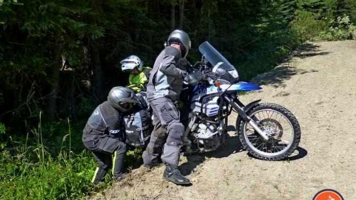 Jim Pruner and friends working together to get a bike out of the ditch.