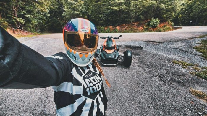 Brittany Morrow taking a selfie with the parked Can-Am Ryker 900 Rally Edition