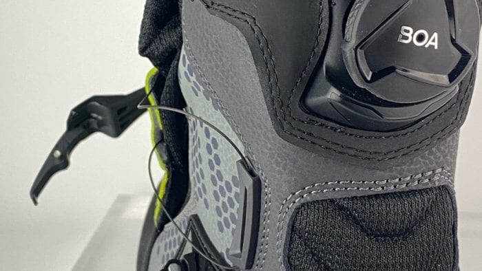 A Klim GTX Adventure boot with the BOA system tension released and the velcro flap opened.