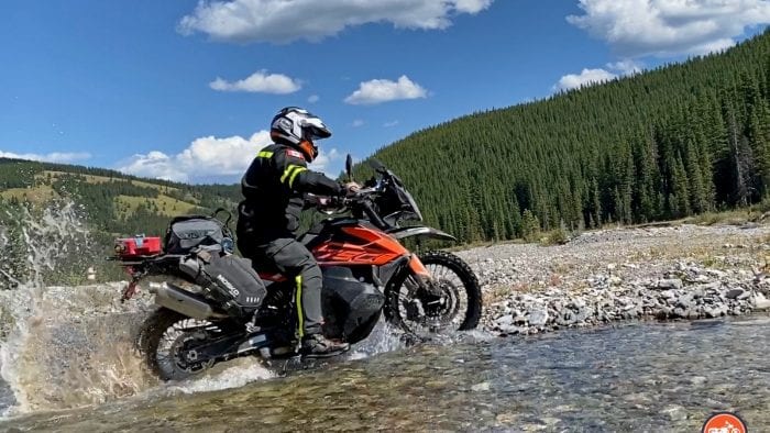 A KTM 790 adventure crossing a stream.