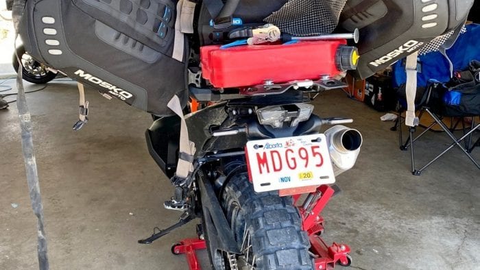 The Mosko Moto Reckless 80L V3.0 Revolver half removed from a KTM 790 adventure to access under the seat.