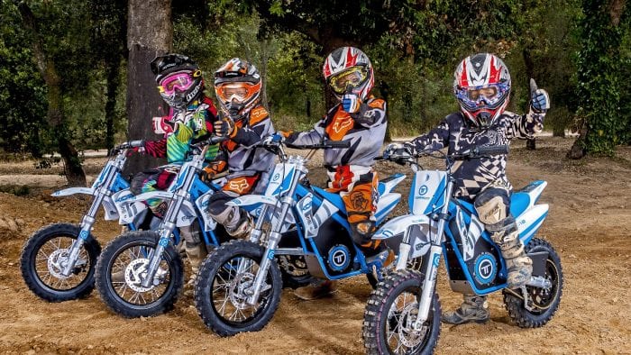 A line of kids trying out the Torrot electric dirt bikes