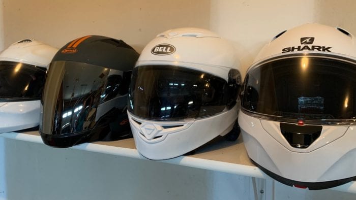 Motorcycle helmets on a shelf