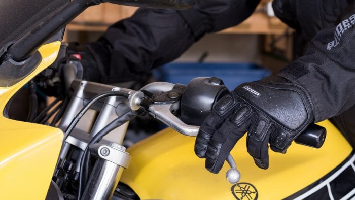 Simon Bertram wearing the Icon SuperDuty II gloves pressing the clutch