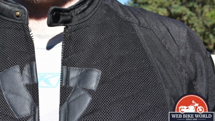 A view of the KLIM Aggressor -1.0 Cooling Shirt underneath the model's usual motorcycle attire.