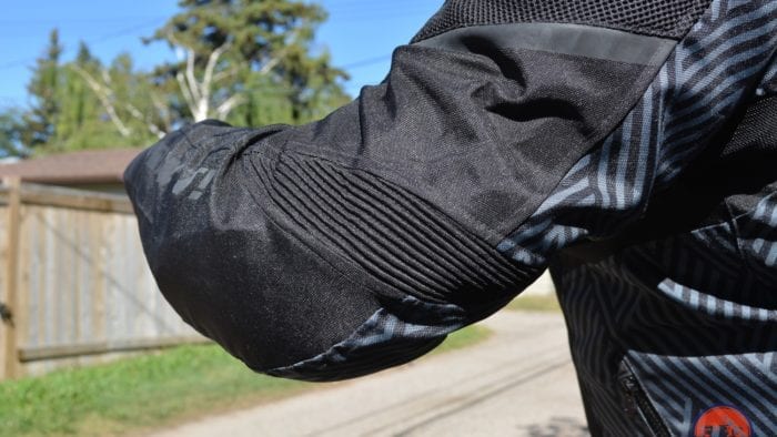 A back left elbow view of the Arc Air Mesh jacket, with focus on the accordion zones