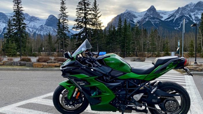 A view of a Kawasaki Ninja H2SX SE with mountains in the background