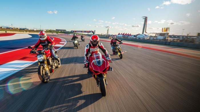 A view of registrars of the 23019 Ducati Island Experience, trying out the COTA MotoGP track in a parade lap.
