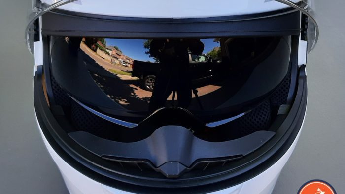 A view of the white Outrush R Modular Helmet, with the sunglasses option flipped down