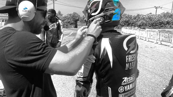 A view of coaches training racers and using the Cardo Systems Packtalk headphones