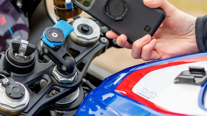 A rider on a BMW motorcycle, trying out the Quad Lock phone mount