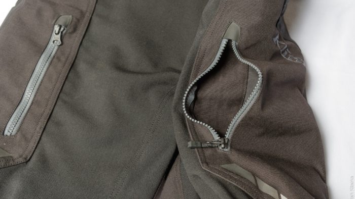 Closeup showing open upper zippered thigh pockets