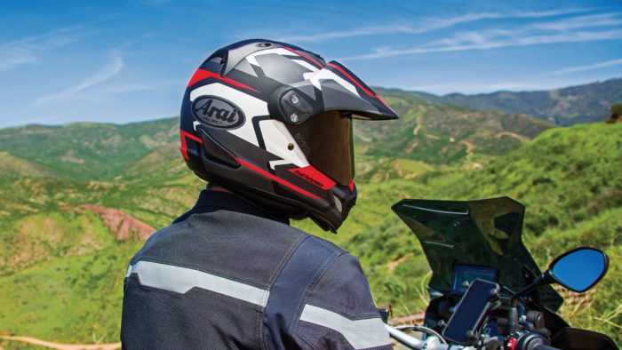 A view of a rider trying out the Arai XD4, with a rugged topography in the background