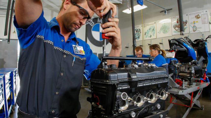 A worker wrenching on a BMW Bike at the Universal Technical Institute (UTI)