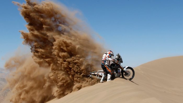 A rider racing in an enduro event similar to the 2021 Morocco Rally or the Dakar Rally