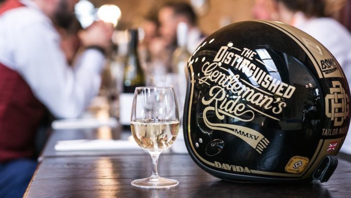 A view of a Distinguished Gentleman's Ride helmet with a glass of champagne
