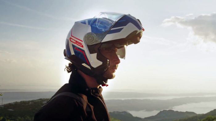 A side view of a model trying on the new C5 helmet from Schuberth