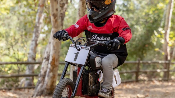 a young rider trying out the new sFTR Mini motorcycle from Indian Motorcycles - an electric-youth bike available to the smaller riding community