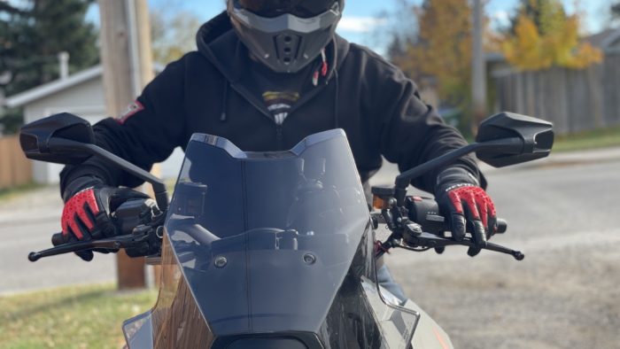 Rider with REV'IT Sand 4 Gloves in black and red with Scorpion Covert X helmet on 2016 KTM Super Duke GT