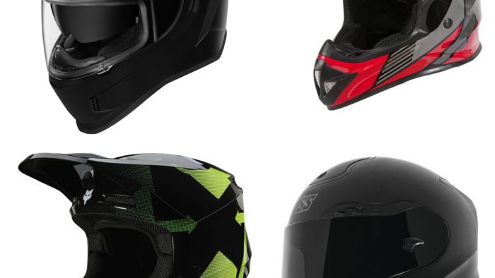 Four motorcycle helmets on white background