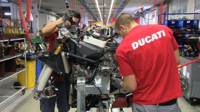 A worker toiling away at a Ducati bike in the creation process
