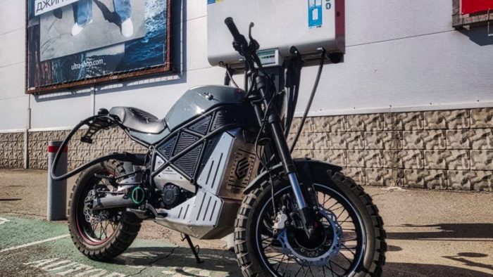 A back view of the ScrAmper - an electric motorcycle from Ukranian brand EMGo, capable of using an electric car charger