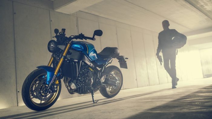 A model posing with the all-new 2022 Yamaha XSR900 - Static images from campaign shoot. Featuring Legend Blue Bike.