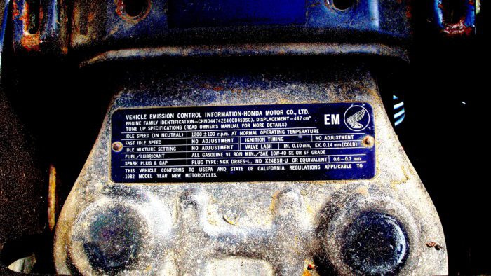 A picture of emissions compliance specs on a Honda motorcycle