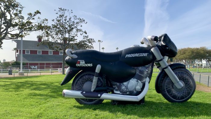 Motorcycle with IMS Outdoors printed on side on grass at 2021 event