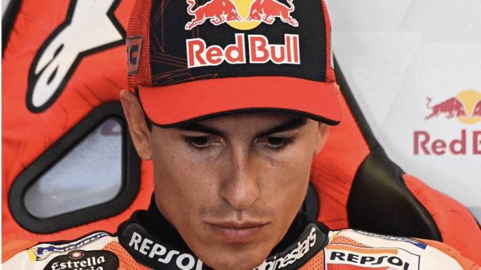 Marc Marquez looks down during a press conference.