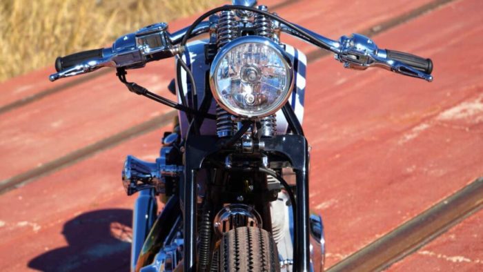 The headlight view from the custom "Springer Bobber Blue" Harley-Davidson Softail Standard Motorcycle from Lord Drake Kustoms
