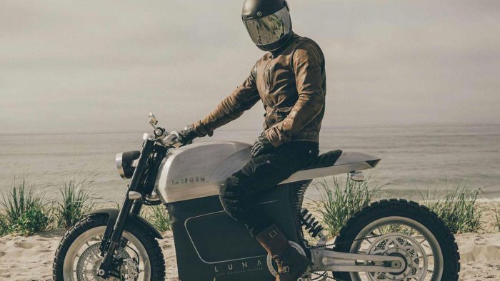 A Zero Motorcycle with a rider stride in front of a desert-like topography