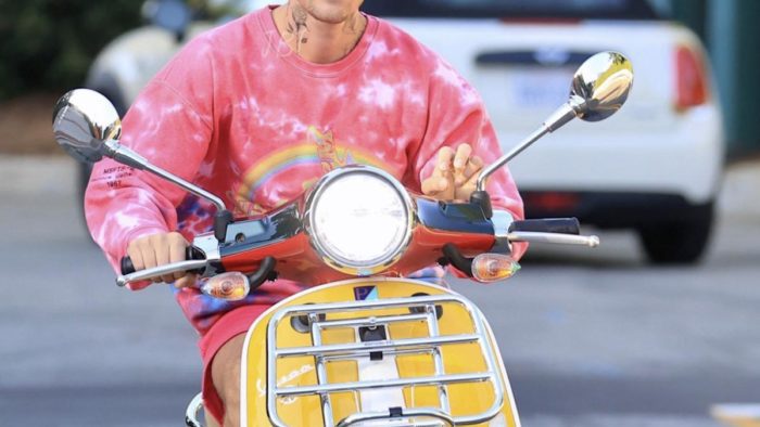 A view of Bieber riding his scooter