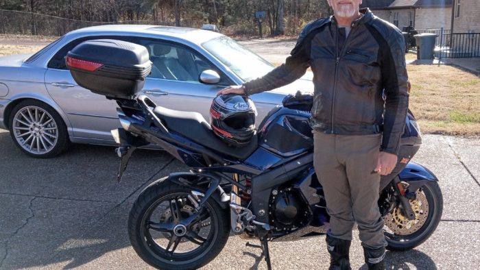 Author standing next to blue Triumph Sprint 1050