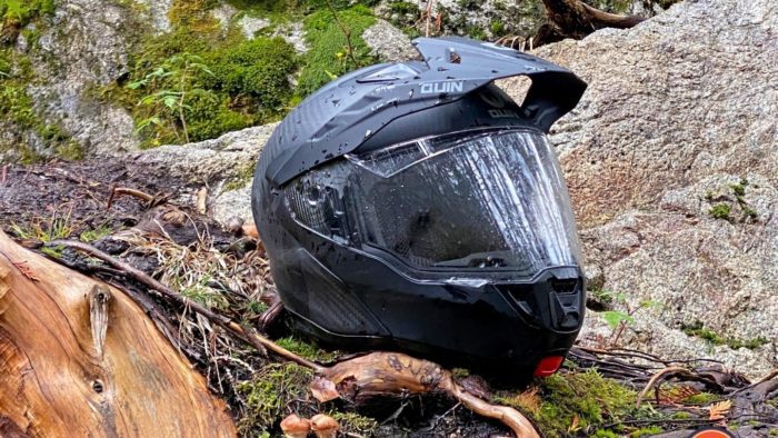 Quin Quest Smart Helmet sitting on mossy rock in forest