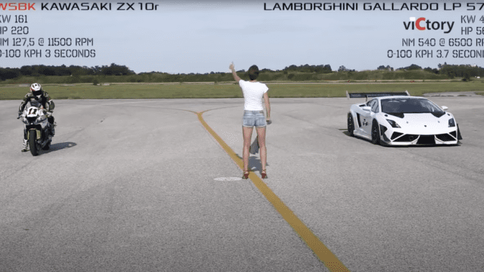 A view of a woman flagging the start of a drag race held in Germany