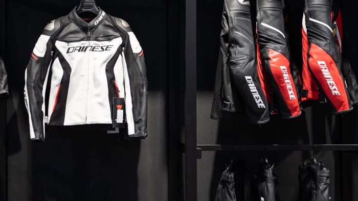 A view of several Dainese motorcycle suits on the rack at a store