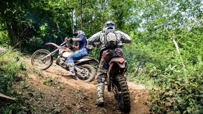 A view of a set of youngsters using a trail for scrambler riding