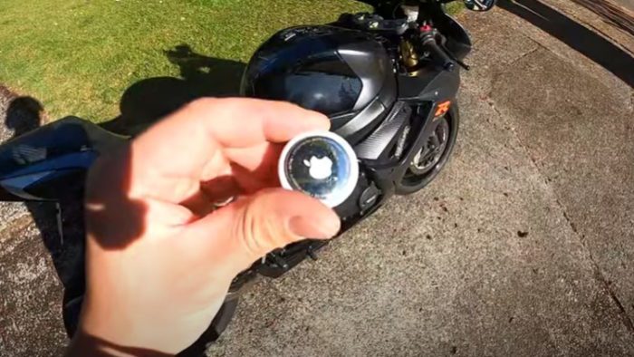 A view of an Apple AirTag next to a motorcycle