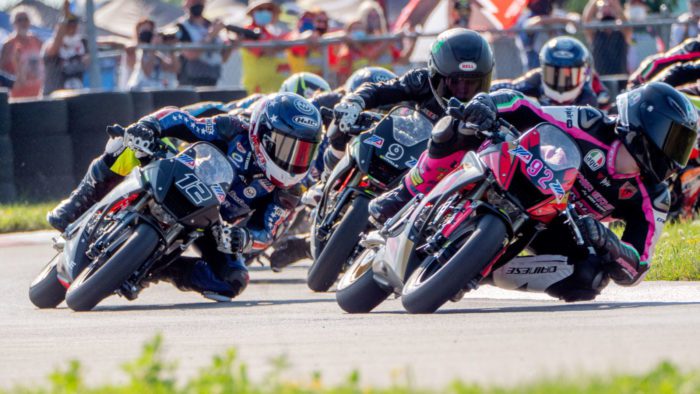 A view of MiniGP riders in the race to win the cup and continue forward in the pursuit toward MotoGP