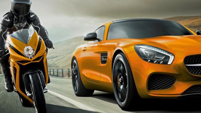 A view of a motorcyclist and a car