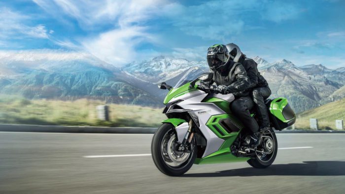 A view of a Kawasaki rider riding beyond a scope of mountains